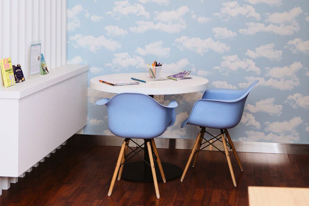 Child-friendly therapy space with cloud wallpaper at Vivamus clinic in Dubai