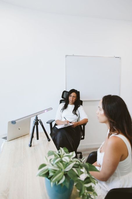 Therapist guiding a client through an EMDR session at Vivamus clinic Dubai, using bilateral stimulation equipment in a supportive and professional environment