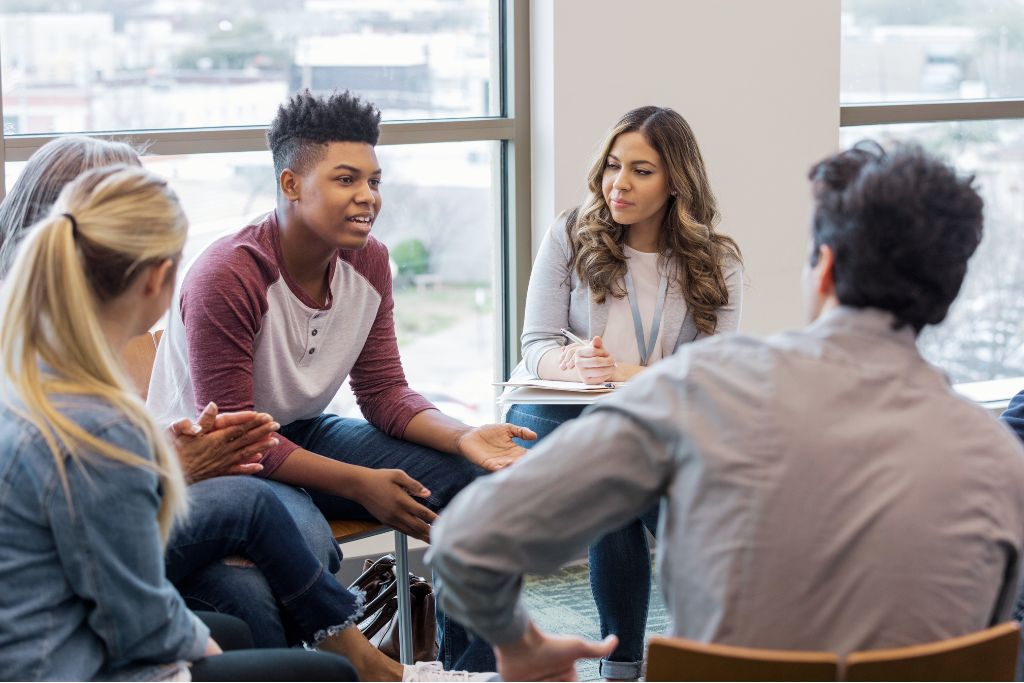 Students and a facilitator engaged in a school wellbeing and support group session