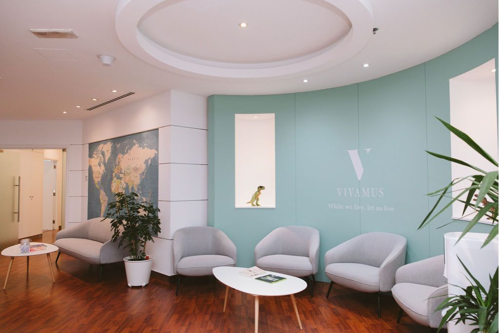 Vivamus clinic child-friendly waiting area with map wall and soft seating in Dubai