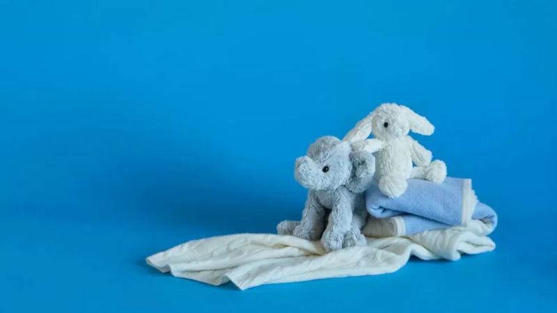 Soft toys and baby blankets symbolising the emotional impact of birth trauma