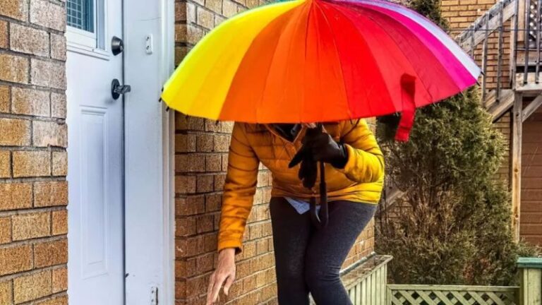 Person holding colourful umbrella symbolising protection and caregiving