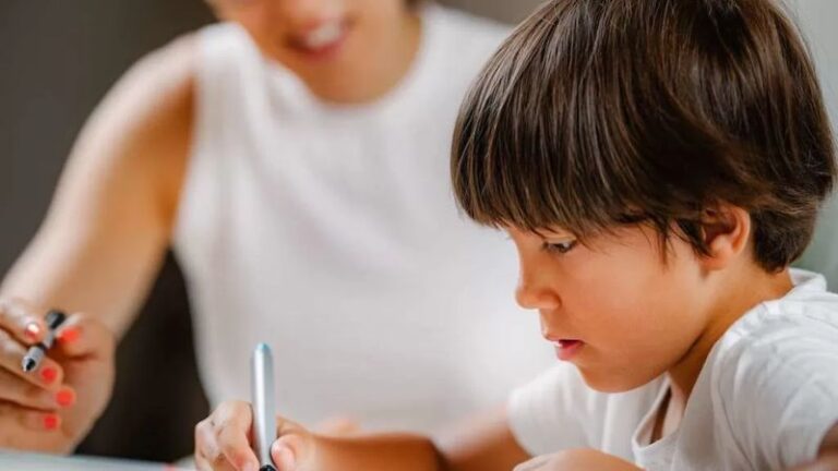 Therapist working with a young boy on an assessment activity