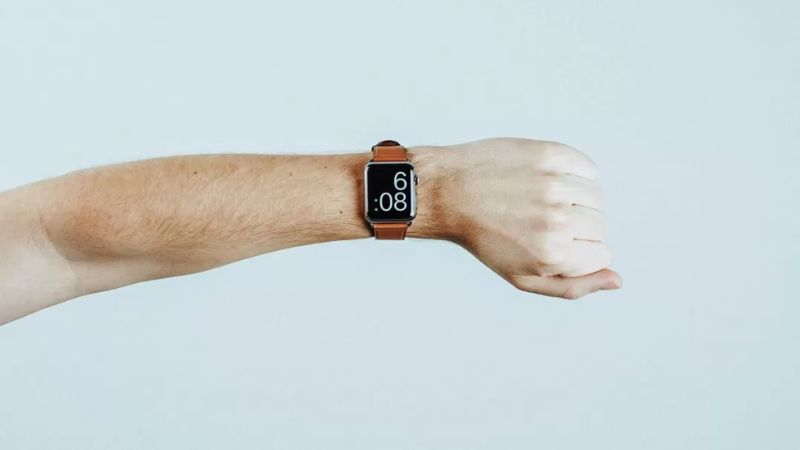 Outstretched arm with watch symbolising the time-sensitive relief of EMDR Intensives