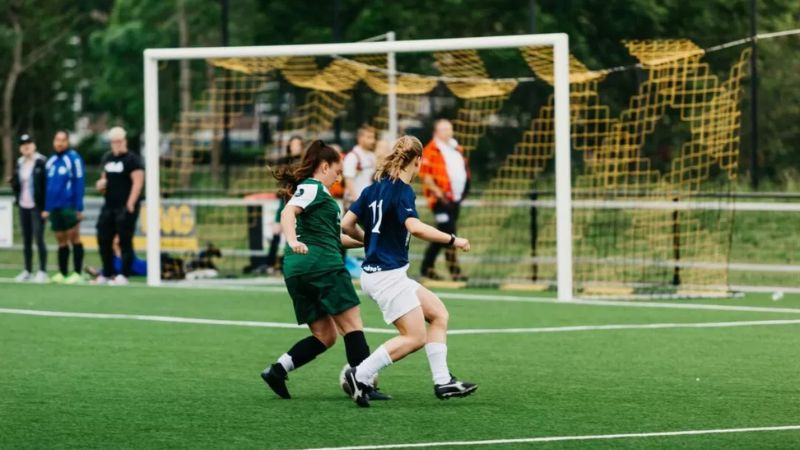 People playing football to highlight the benefits of physical activity for wellbeing