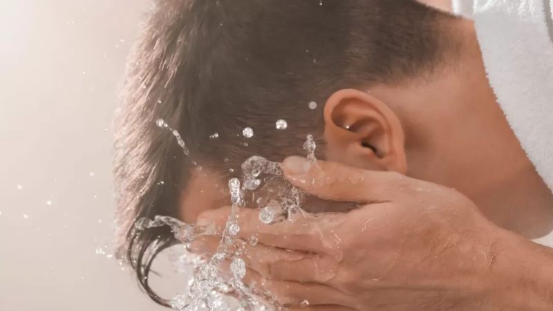 Man splashing water on face representing the intensity and coping of panic attacks